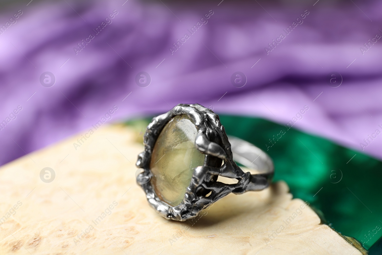 Photo of Beautiful silver ring with prehnite gemstone on textured surface