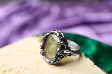 Beautiful silver ring with prehnite gemstone on textured surface