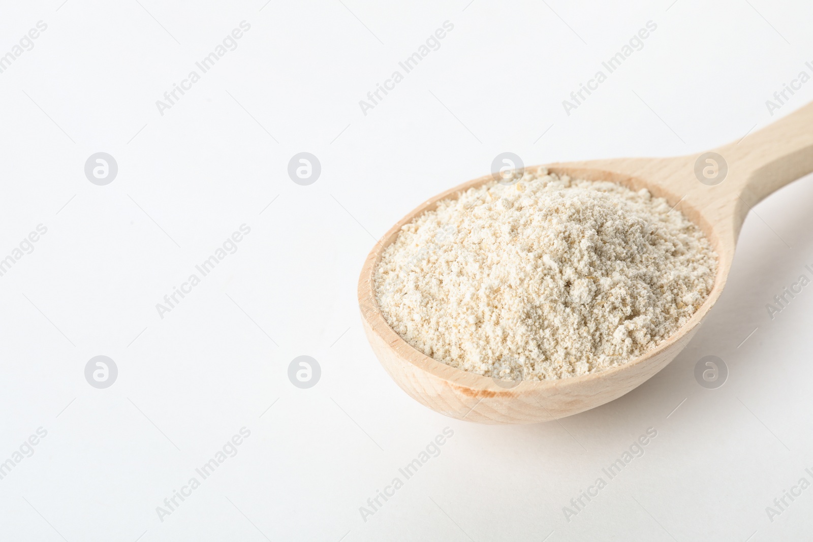 Photo of Spoon of oat flour isolated on white. Space for text