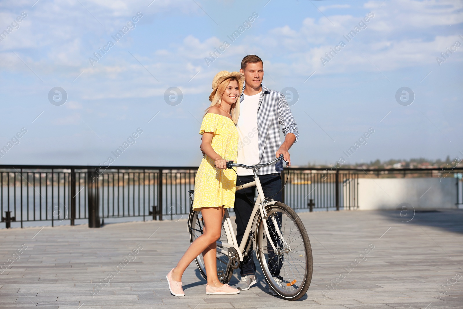 Photo of Happy couple with bicycle outdoors on sunny day