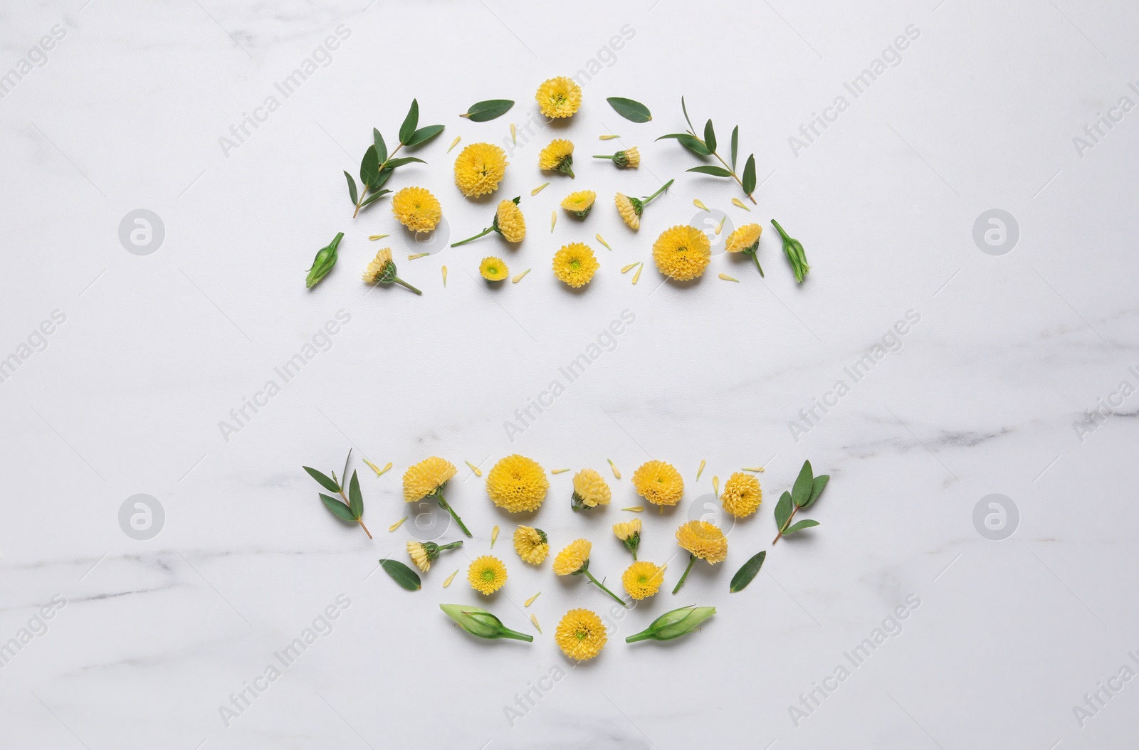 Photo of Wreath made of chrysanthemum flowers and green leaves on white marble background, flat lay. Space for text