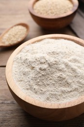 Photo of Quinoa flour in bowl on wooden table