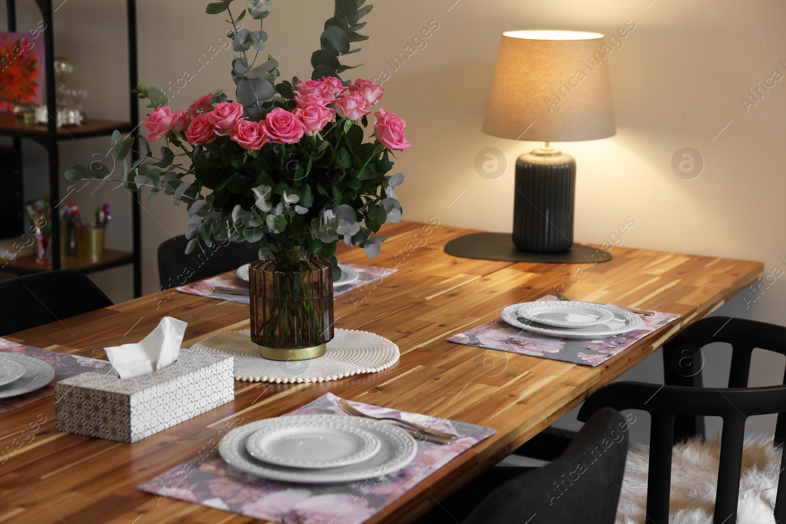 Photo of Beautiful table setting with bouquet and napkins indoors. Roses and eucalyptus branches in vase