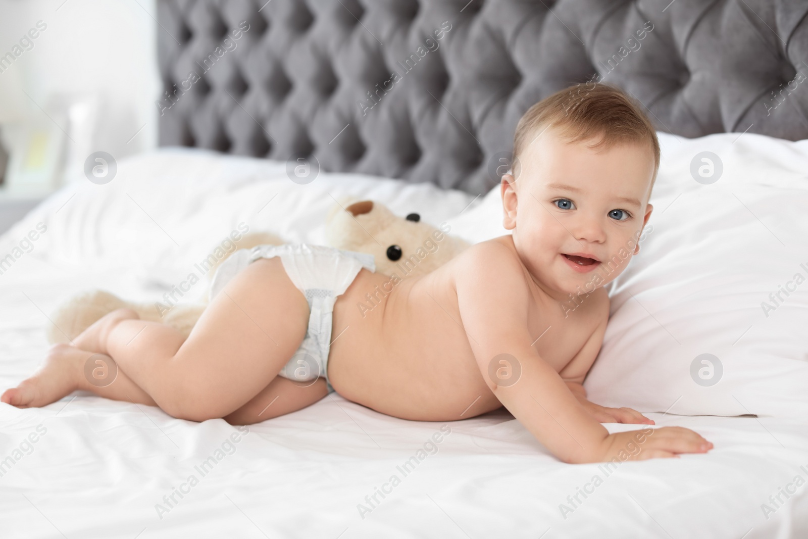 Photo of Adorable little baby on bed at home