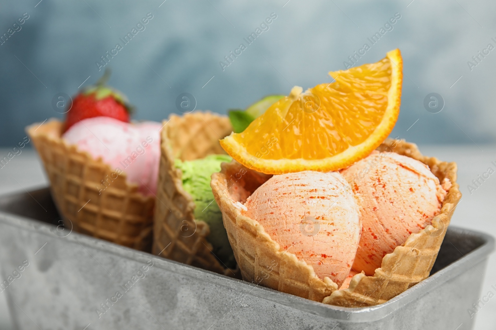 Photo of Delicious ice creams in waffle cones served on table, closeup