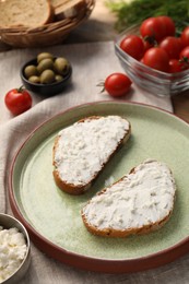 Photo of Delicious ricotta bruschettas and products on wooden table