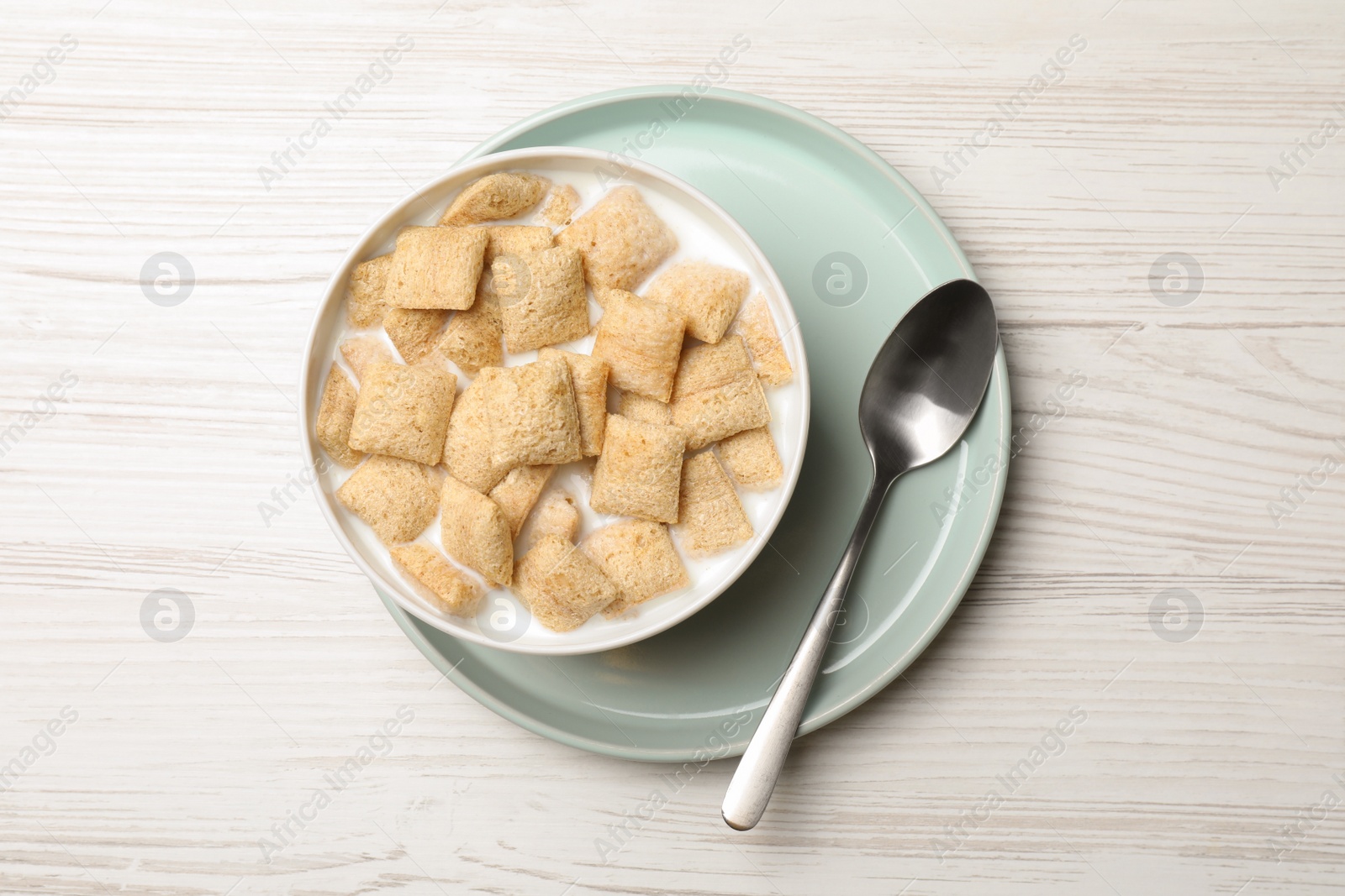 Photo of Tasty corn pads with milk served for breakfast on white wooden table, flat lay