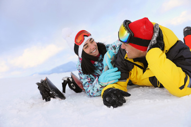 Photo of Lovely couple on snowy hill. Winter vacation