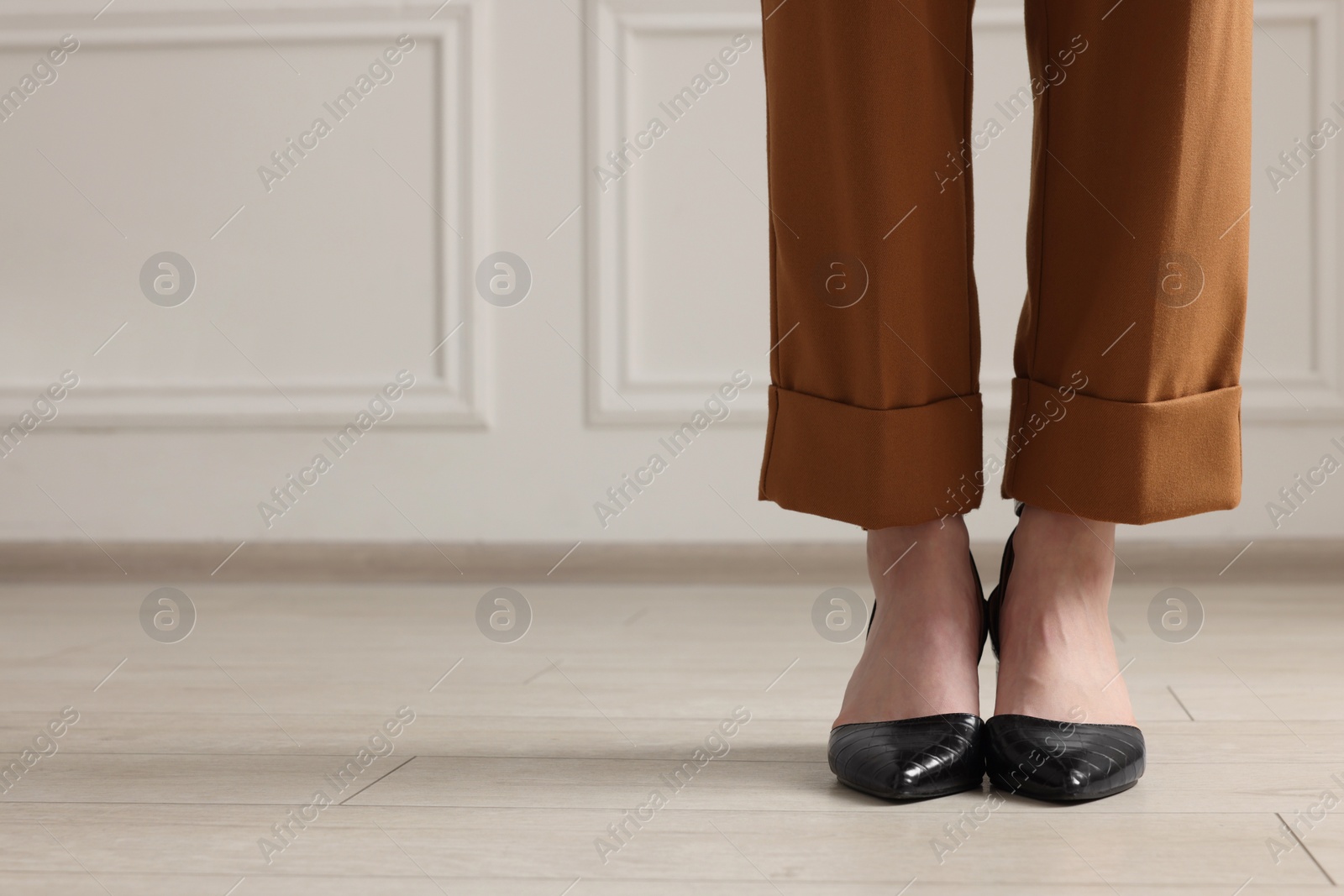 Photo of Businesswoman in elegant leather shoes indoors, closeup. Space for text