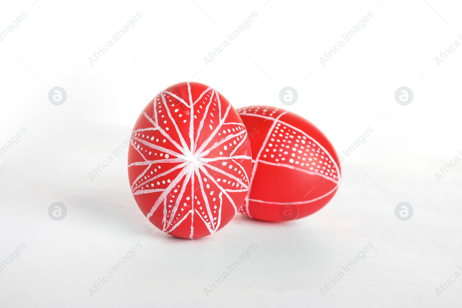 Photo of Creative painted red Easter eggs on white background