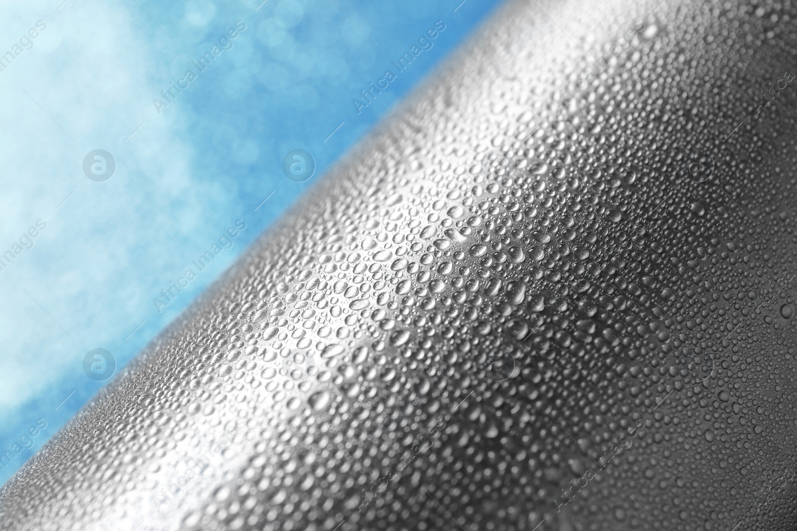 Photo of Aluminum sports water bottle covered with drops, closeup