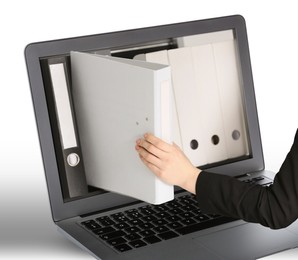 Image of Digital archive. Woman taking folder right from laptop screen, closeup