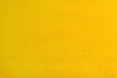 Texture of yellow wooden surface as background, closeup