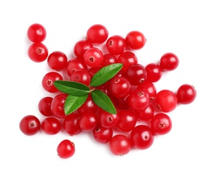 Photo of Pile of fresh ripe cranberries with leaves on white background, top view
