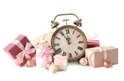 Photo of Alarm clock, gifts and festive decor on white background. New Year countdown