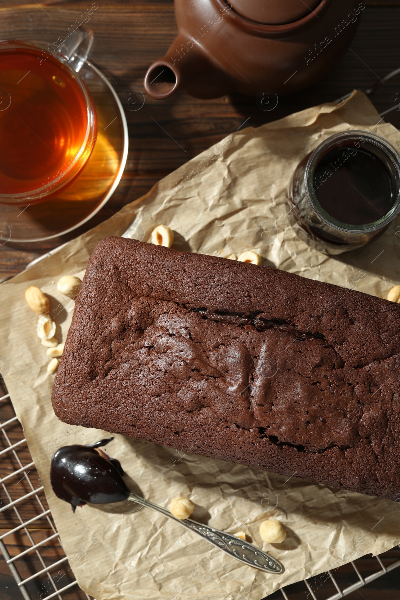 Photo of Flat lay composition with delicious chocolate sponge cake on wooden table