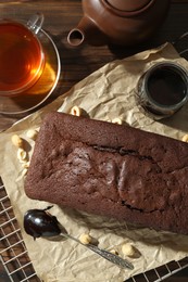 Flat lay composition with delicious chocolate sponge cake on wooden table