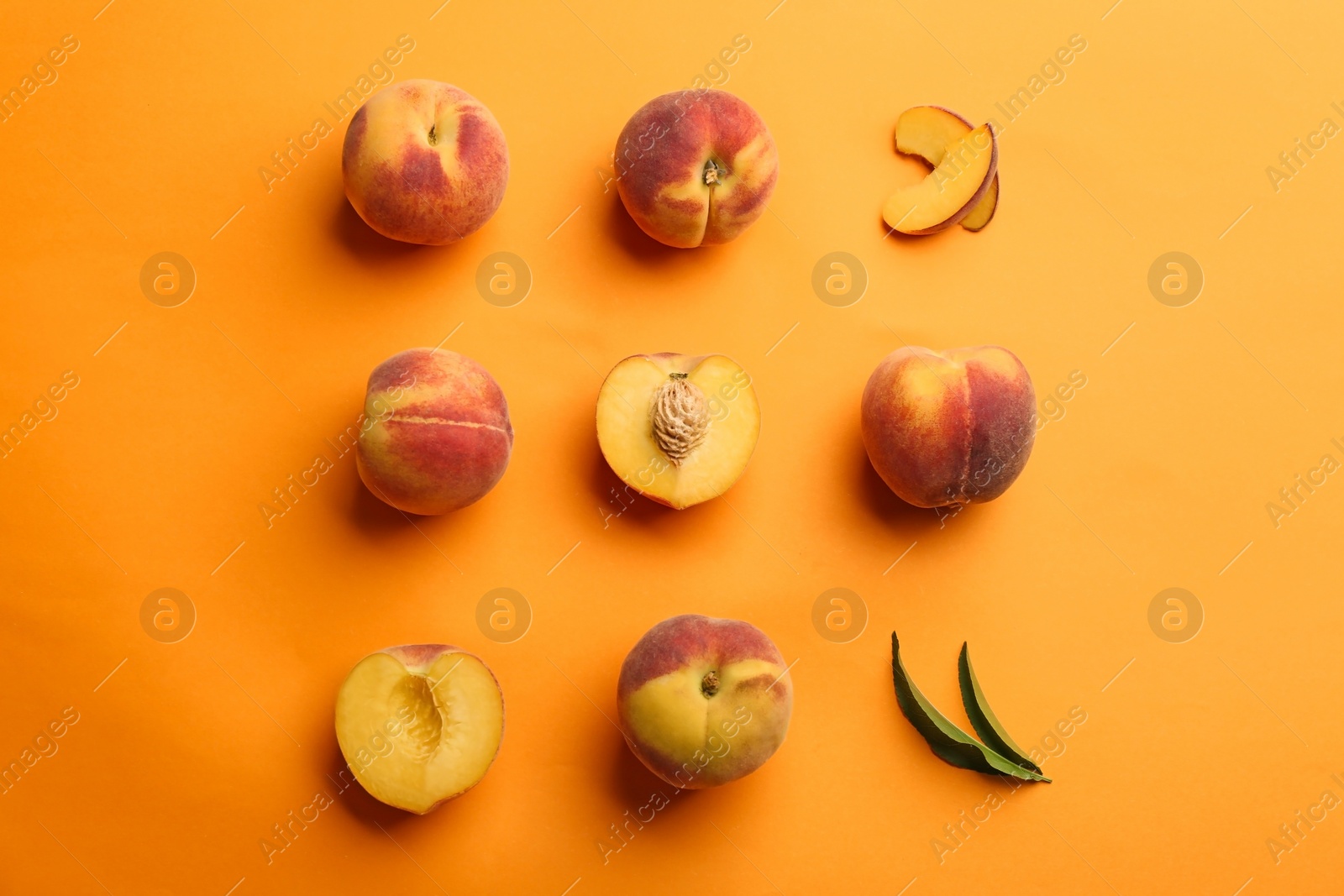 Photo of Flat lay composition with fresh peaches on orange background