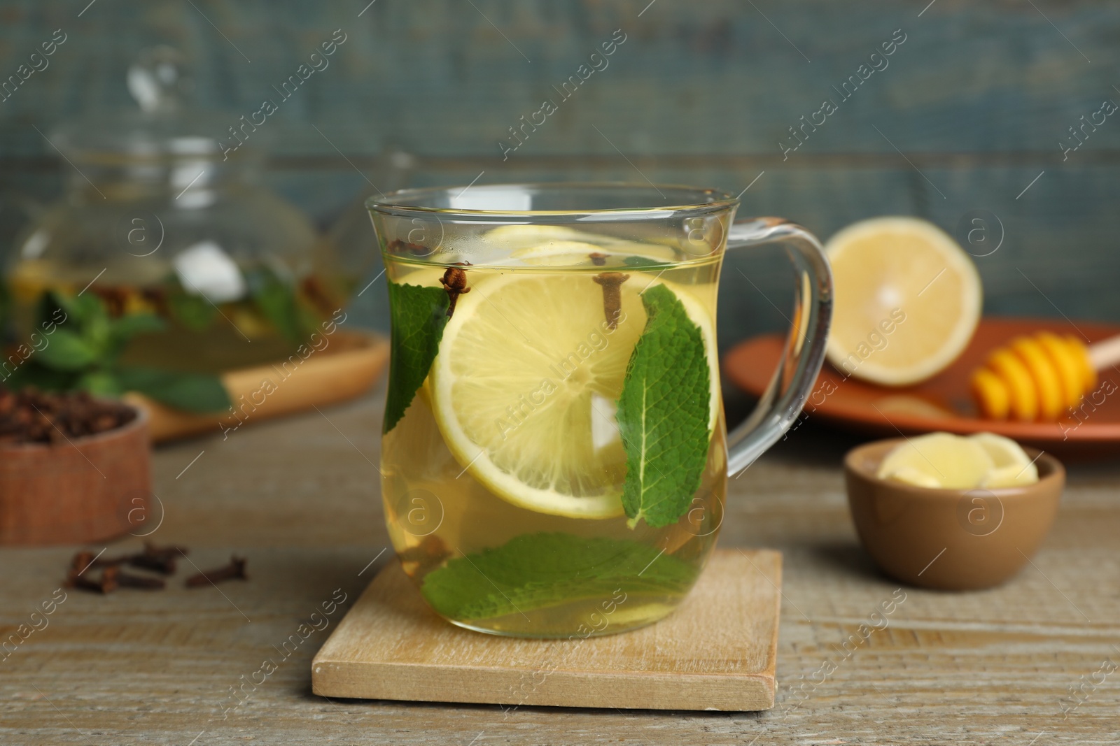 Photo of Glass cup of immunity boosting drink on wooden table