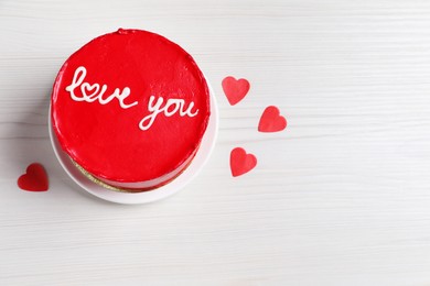 Photo of Bento cake with text Love You, paper hearts and space for text on white wooden table, top view. St. Valentine's day surprise