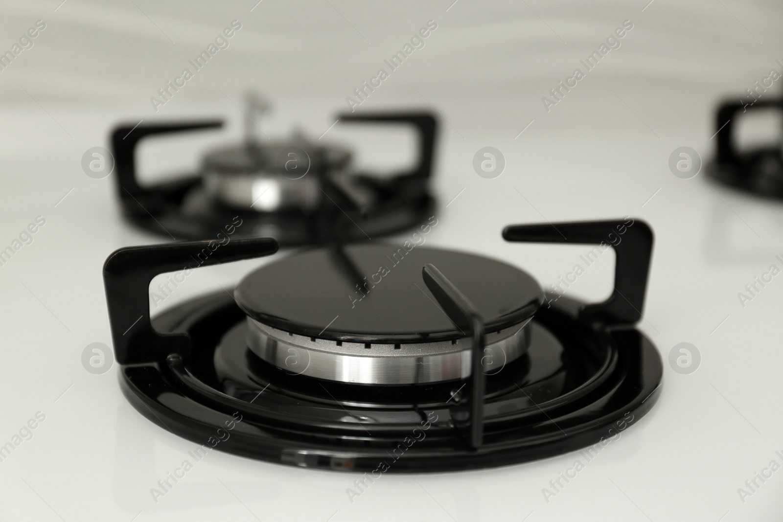 Photo of Modern built-in gas cooktop, closeup. Kitchen appliance