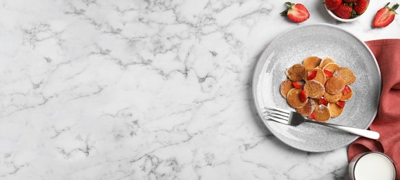Image of Delicious mini pancakes cereal with strawberries served on white marble table, flat lay with space for text. Banner design