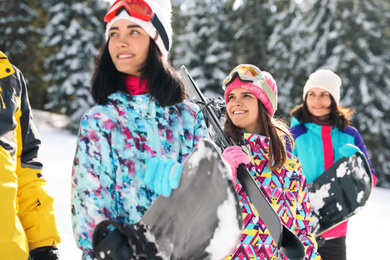 Group of friends with equipment in snowy mountains. Winter vacation