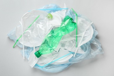 Photo of Pile of different plastic items on white background, flat lay