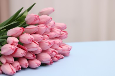 Photo of Bouquet of beautiful pink tulips on light grey background, closeup. Space for text
