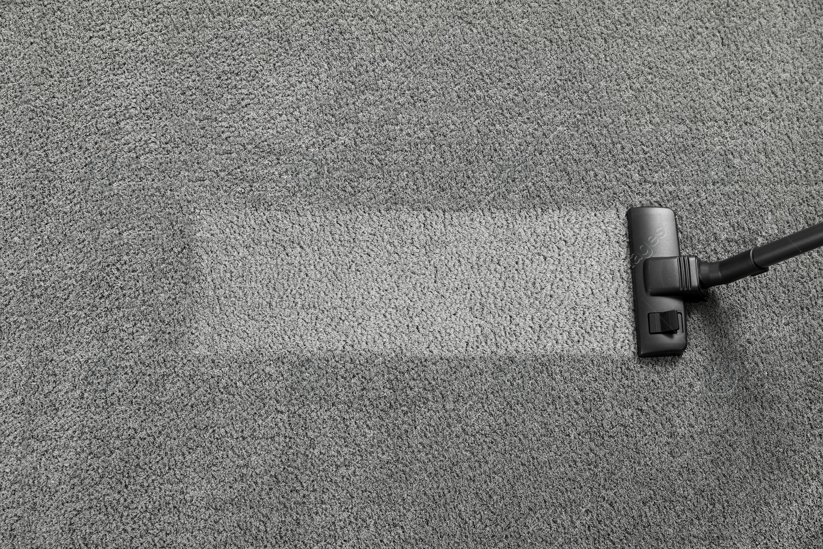 Photo of Vacuuming grey carpet. Clean area after using device, top view. Space for text