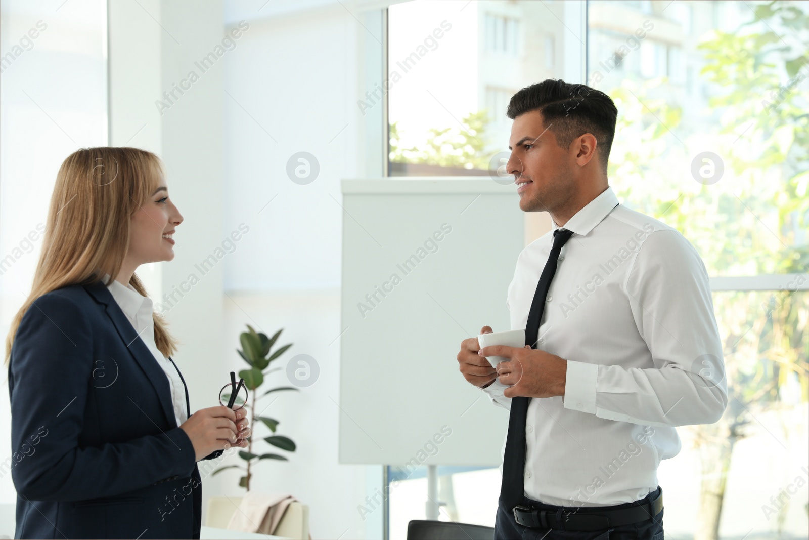 Photo of Office employees talking at workplace during break