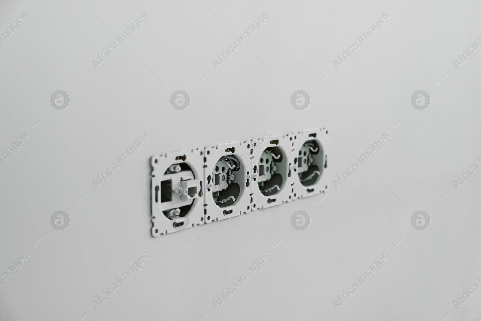 Photo of Electrical sockets with wiring on wall, closeup