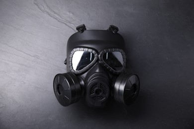 Photo of One gas mask on grey textured background, top view