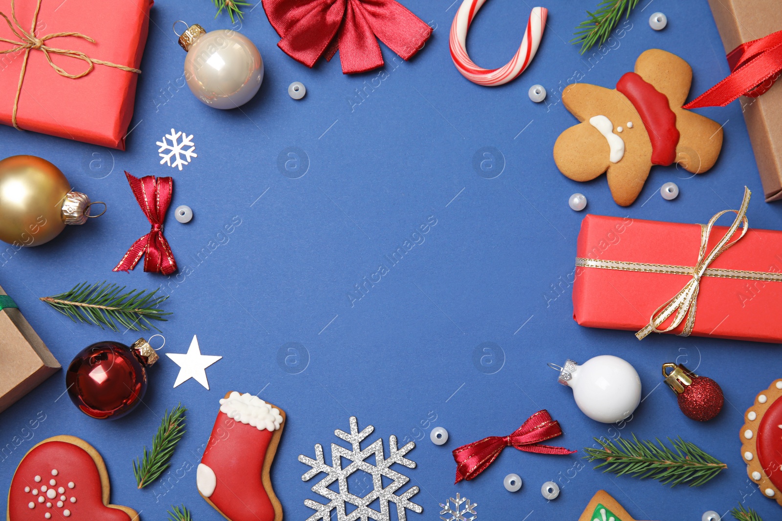 Photo of Frame made with Christmas decor on blue background, flat lay. Space for text