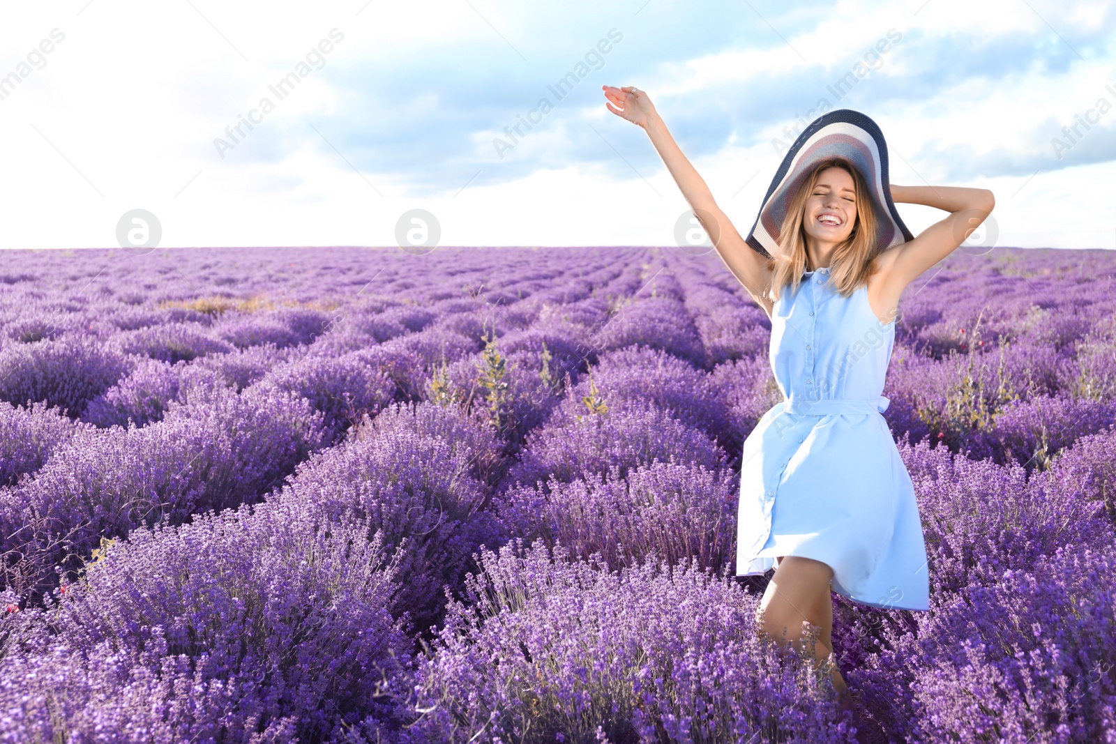 Photo of Young woman in lavender field on summer day