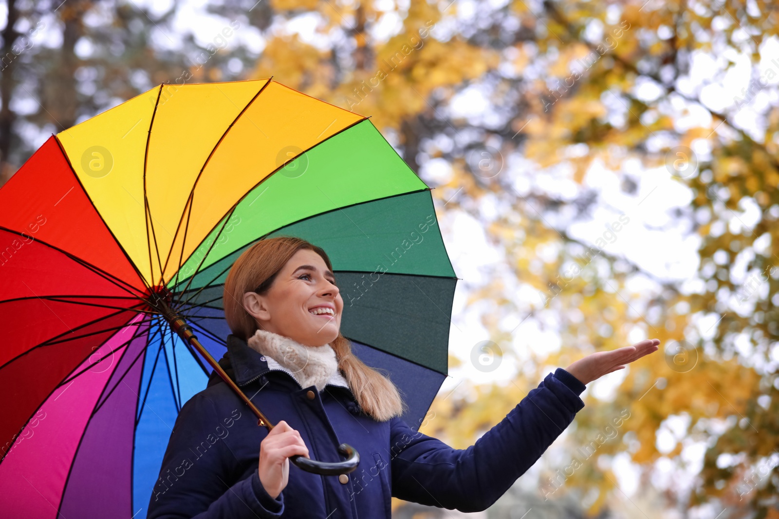 Photo of Woman with umbrella in autumn park on rainy day