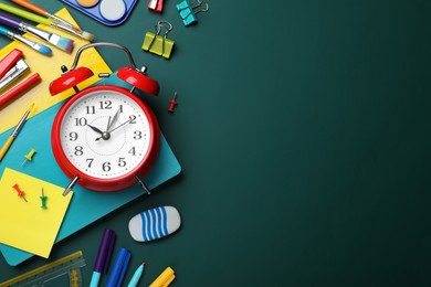 Photo of Flat lay composition with alarm clock and different stationery on green chalkboard, space for text. School time