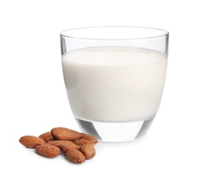 Glass with milk and nuts on white background