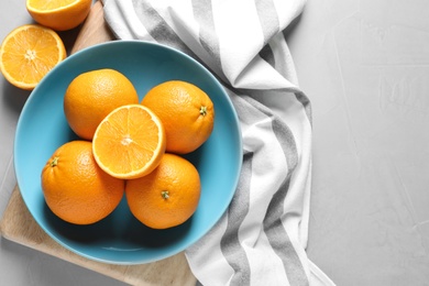 Flat lay composition with ripe oranges and space for text on grey background