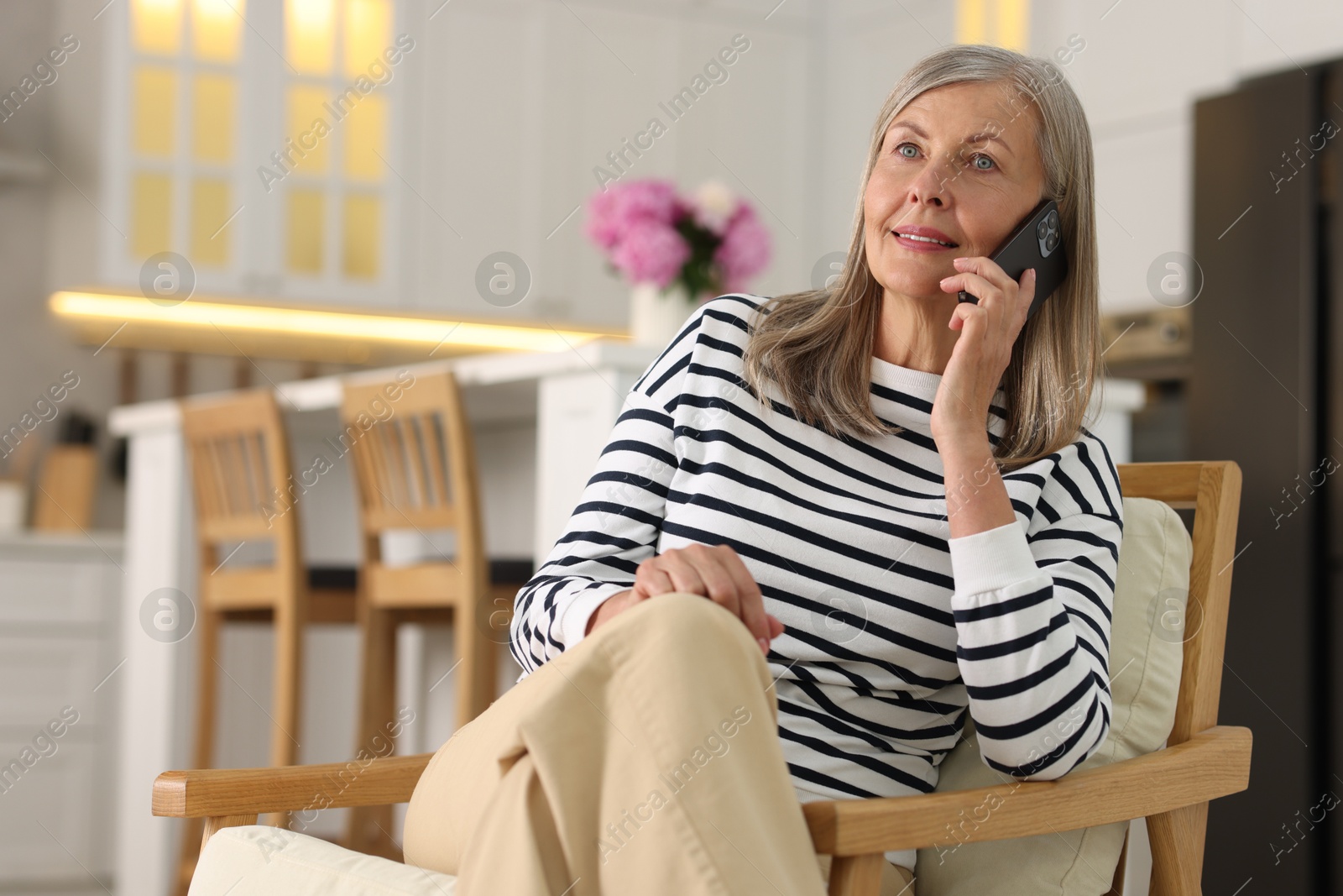 Photo of Senior woman talking on phone at home