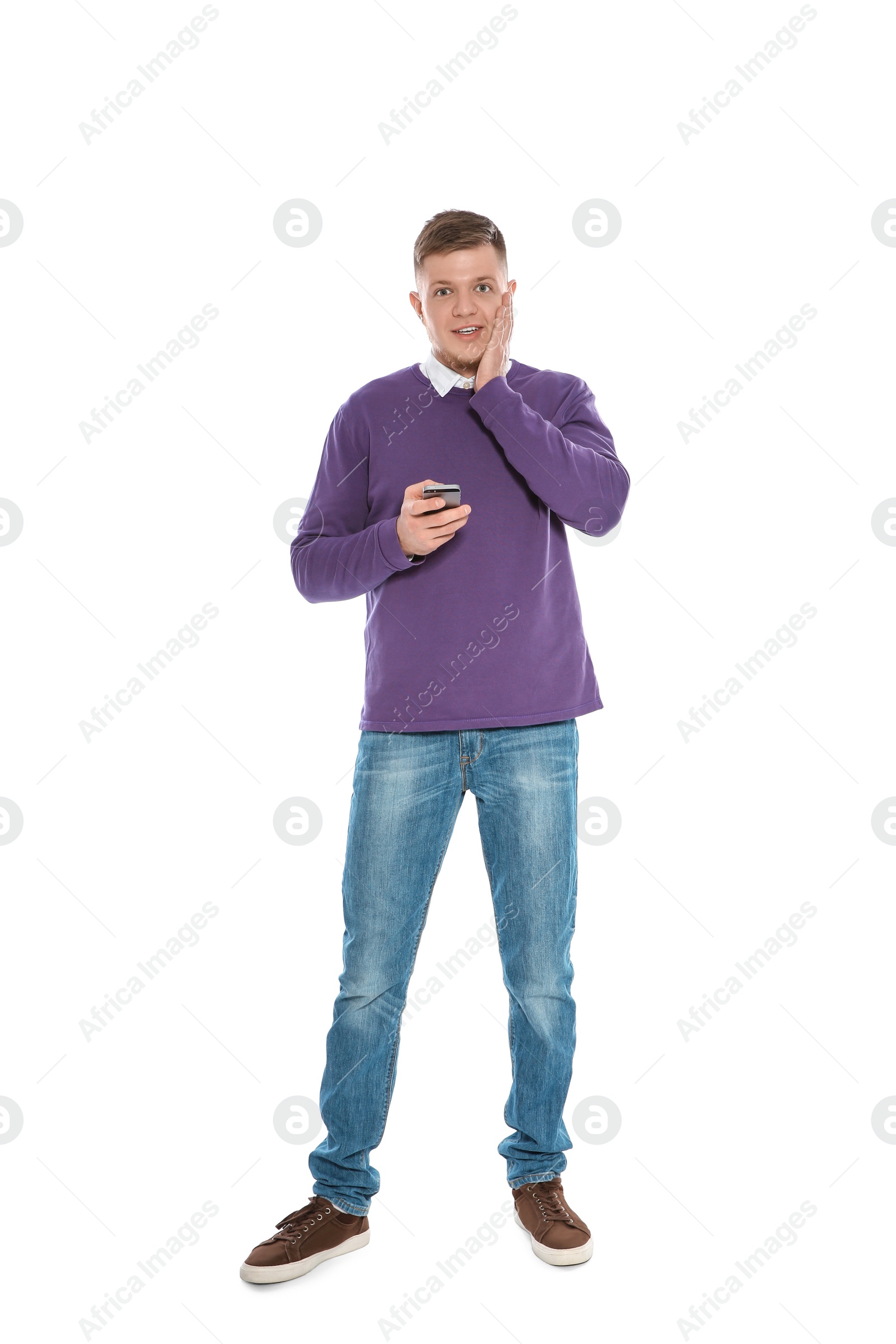 Photo of Handsome young man with phone on white background