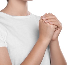 Photo of Woman holding hands clasped while praying on white background, closeup