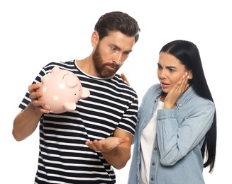 Photo of Couple with ceramic piggy bank on white background