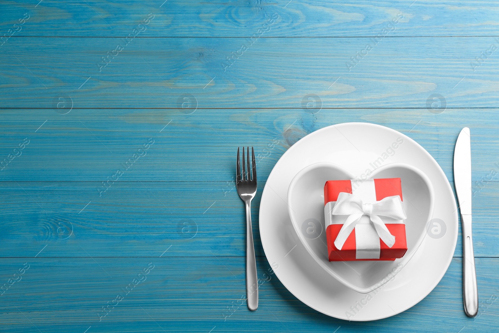 Photo of Beautiful table setting on light blue wooden background, flat lay with space for text. Valentine's Day dinner