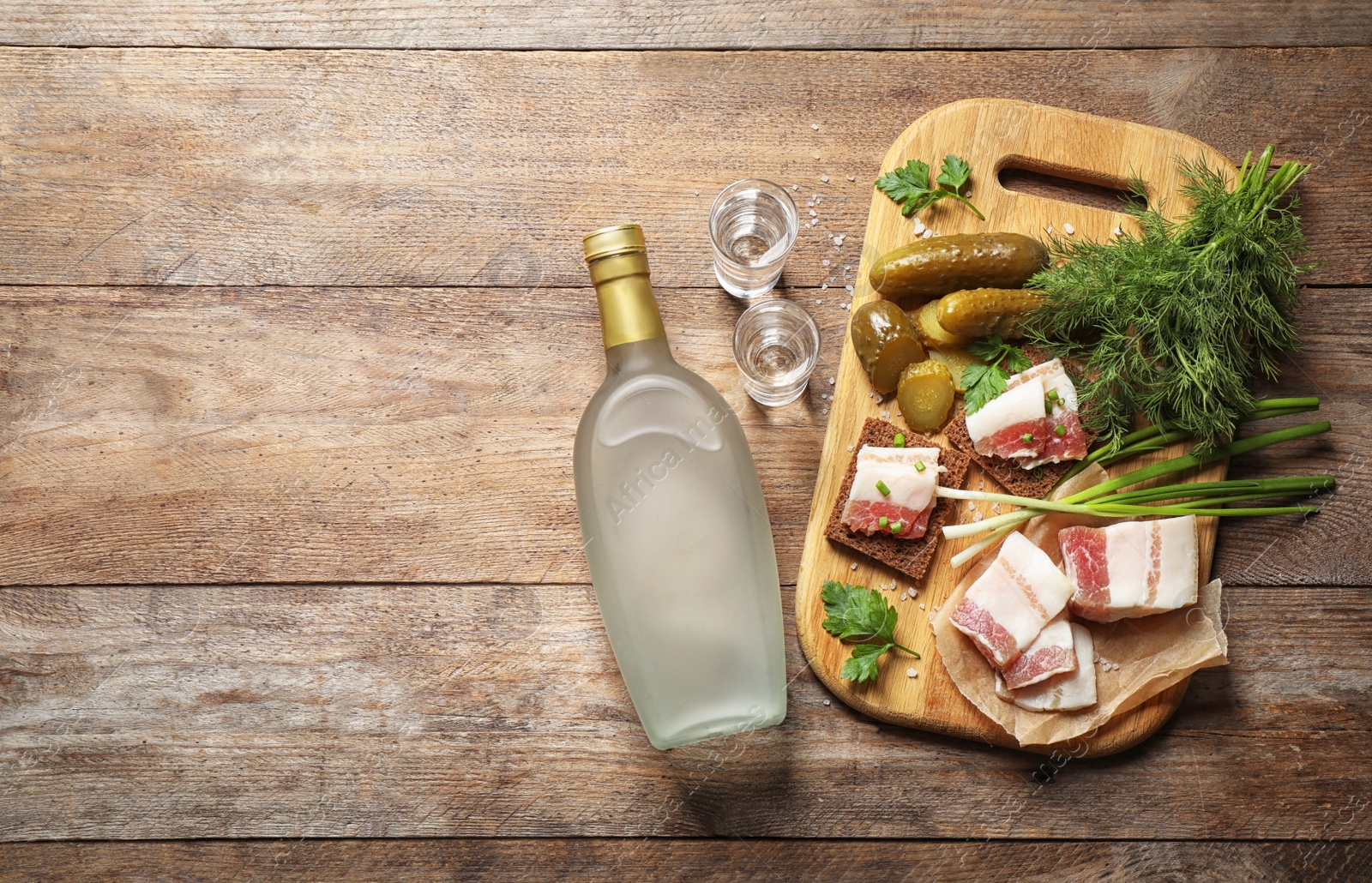 Photo of Flat lay composition with cold Russian vodka on wooden table. Space for text