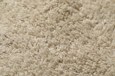 Photo of Texture of soft beige fabric as background, closeup