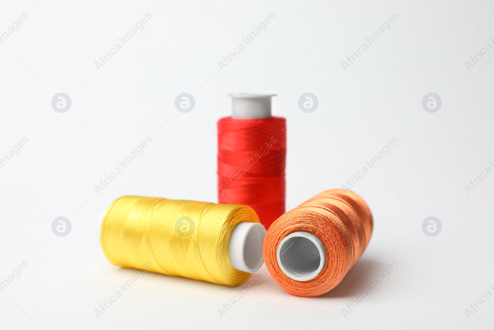 Photo of Color sewing threads on white background