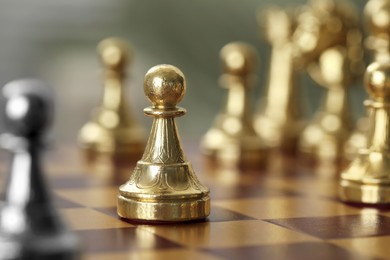 Photo of Golden pawn on chess board, closeup. Space for text