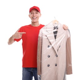 Photo of Dry-cleaning delivery. Happy courier holding coat in plastic bag on white background