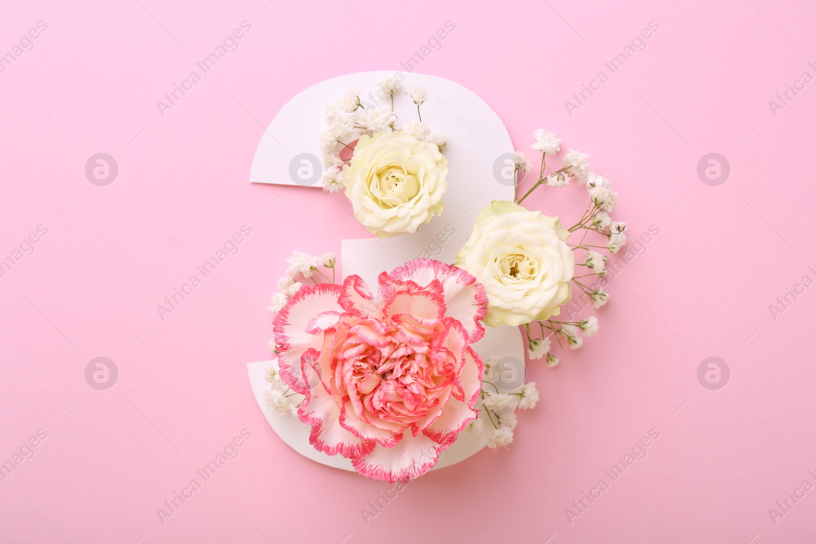 Photo of Paper number 3 and beautiful flowers on pink background, top view